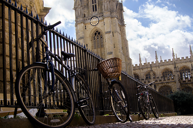 Three bicycles chained to railings in Radcliffe Square, Oxford
